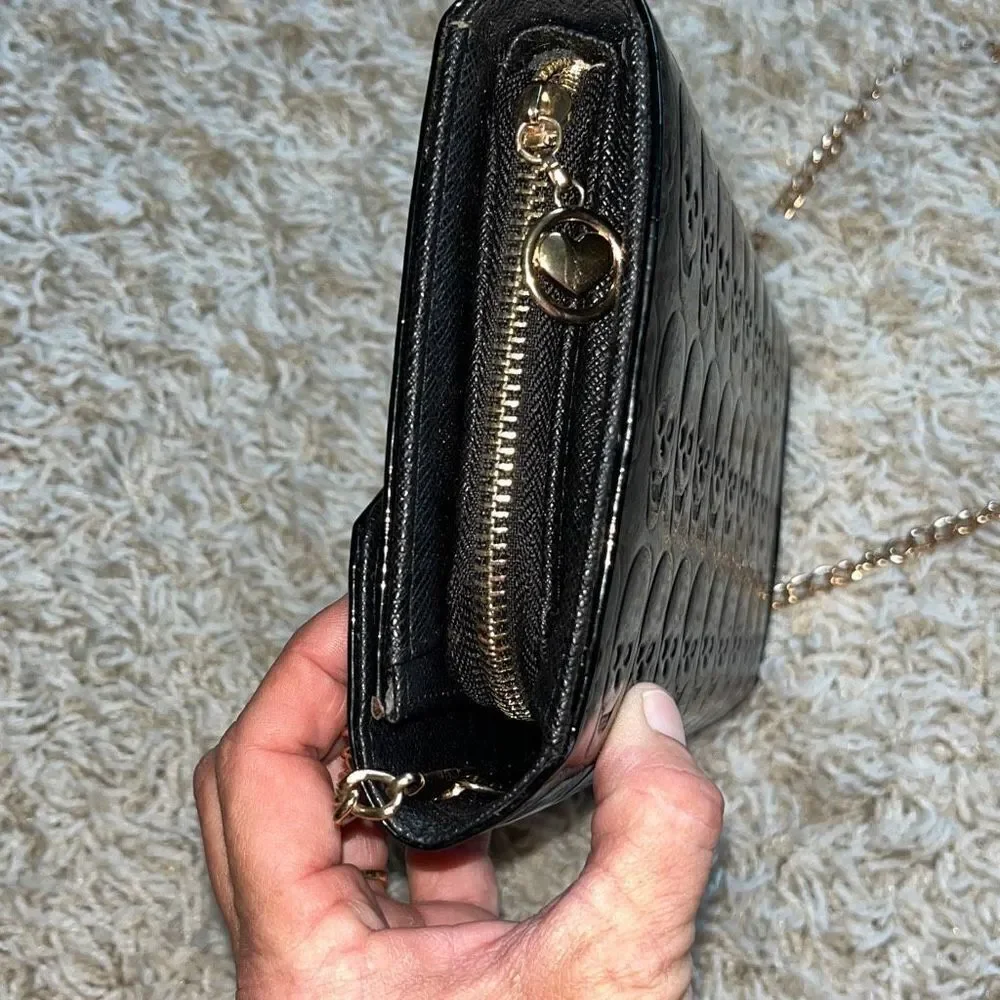 Awesome patent leather skull embossed clutch bag with gold chain shoulder strap.